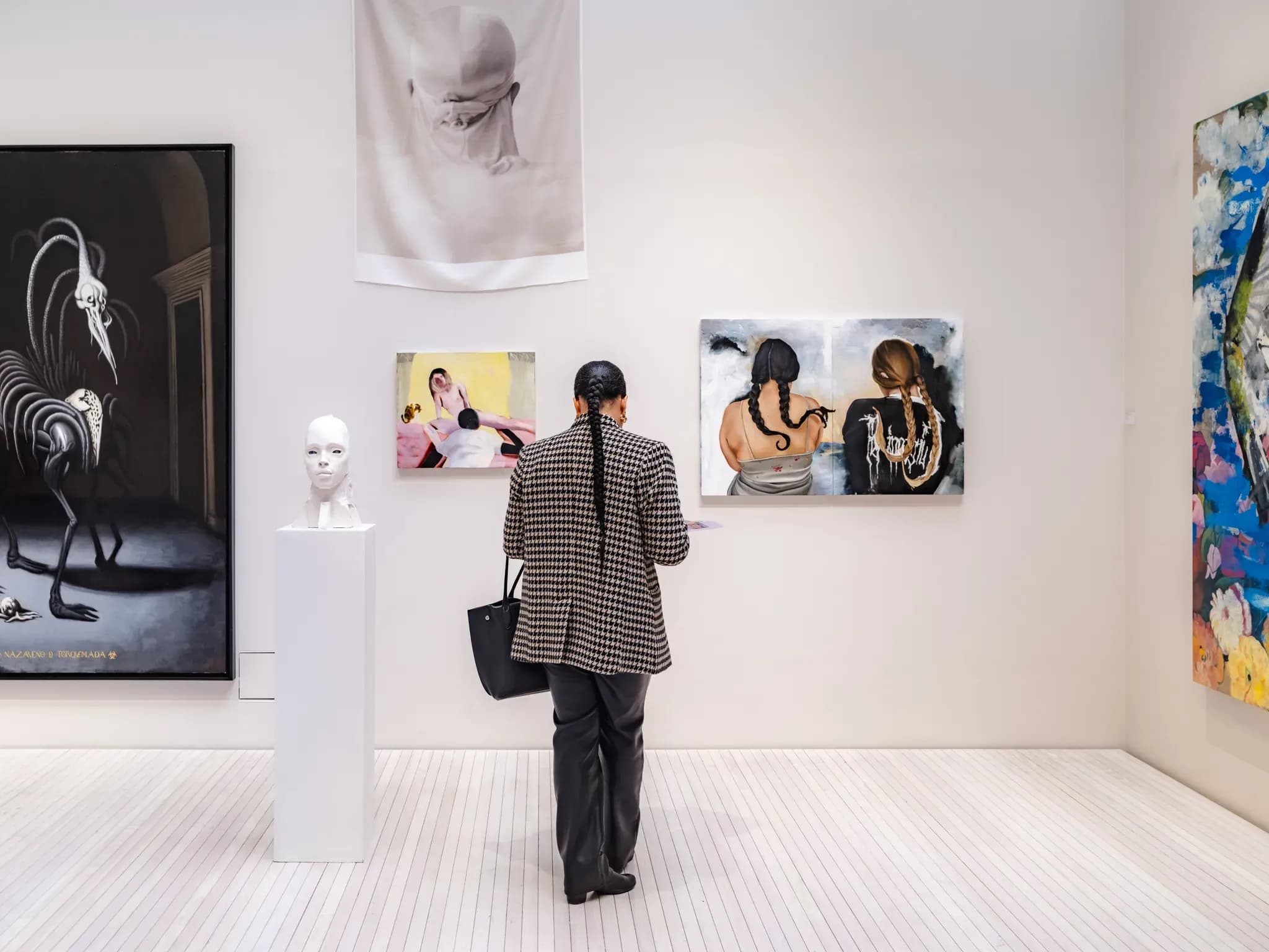 woman at art fair in front of paintings