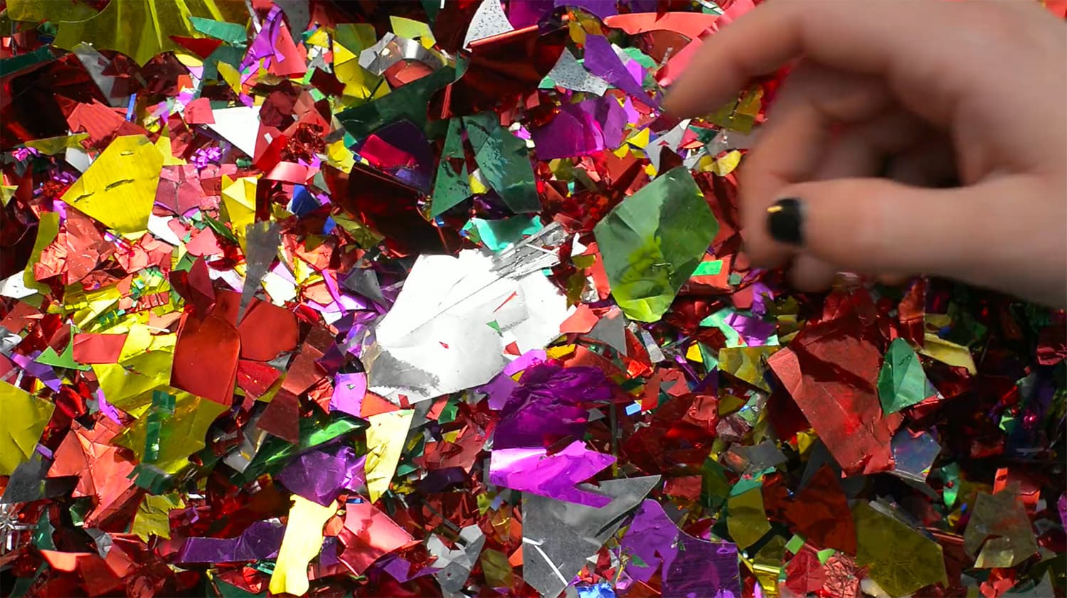 Photo of confetti and a hand