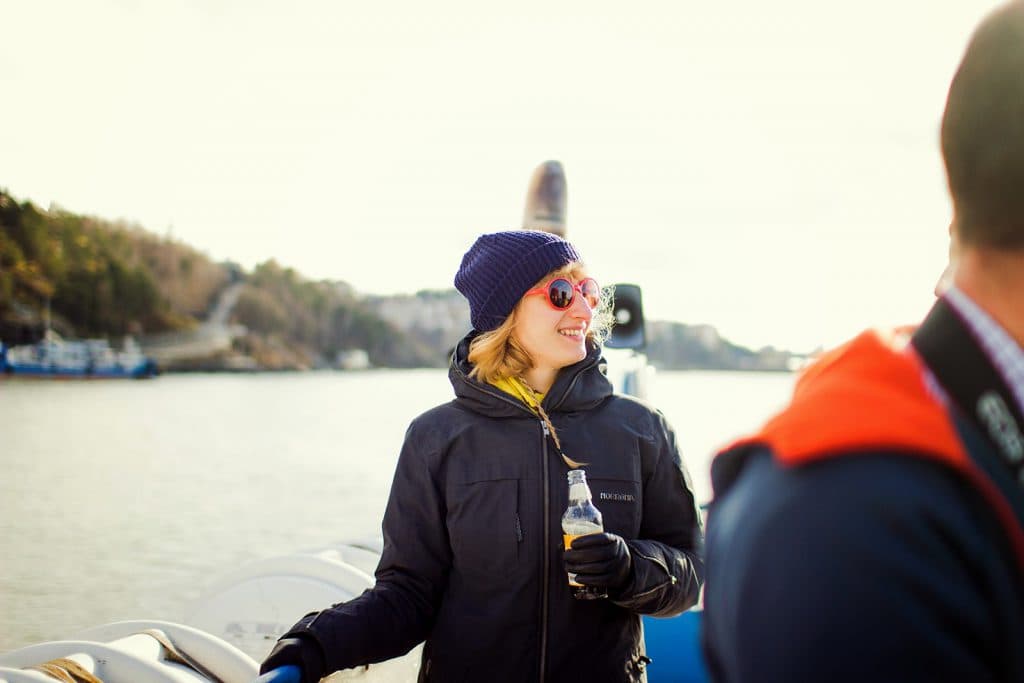 a woman on a ferry, outside in the sun